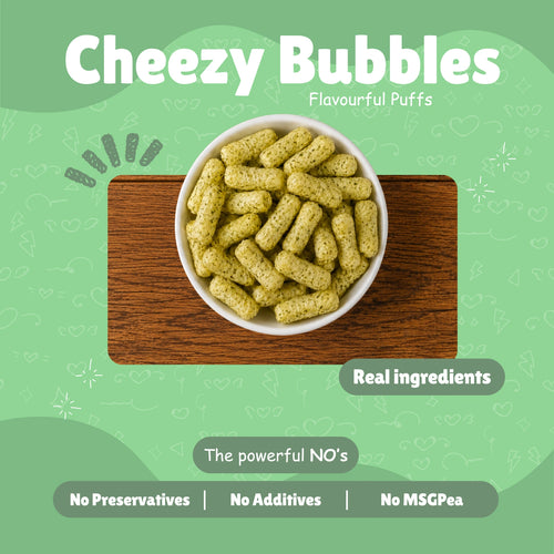 Bowl of Cheezy Bubbles baked millet puff snacks on a wooden board — Real Ingredients, No Preservatives, No Additives, No MSG — on light green background